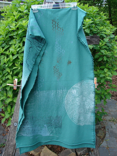 Barclay Heavy Weight Organic Sweatshirt Art Wrap Moon Garden Emerald OSFA draped over a wooden bench, showcasing wavy diamond patterns and circular designs, reflecting Bluefishfinder.com's unique, expressive vintage style.