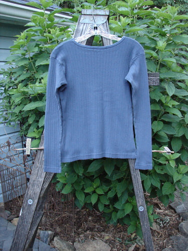 1998 Pointelle Long Sleeved Undertop Top Unpainted Orion Size 0 on a clothes rack, showcasing its soft rib knit pointelle pattern, slightly longer sleeves, and rolled neckline, ideal for layering.