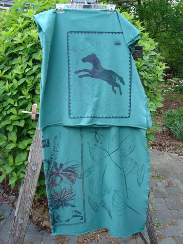 Barclay Heavy Weight Organic Sweatshirt Blanket Pony Garden Emerald OSFA displayed on a garden ladder, showcasing a primitive pony silhouette and botanical line-drawings, embodying Bluefishfinder.com's unique vintage aesthetic.