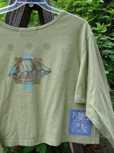 1997 Long Sleeved Crop Tee Butterfly Pear Size 2 with drop shoulders, wide A-line shape, side vents, and a blue patch, showcasing a continuous butterfly design on organic cotton.