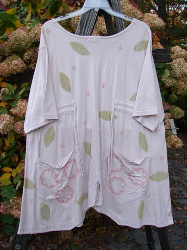 Barclay tunic top with leaf pattern, wide sleeves, and vented hemline.