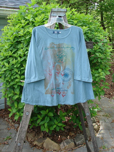 Barclay Three Quarter Sleeved A Lined Tee Creativity Everyday Dusty Sky Size 0, draped on a ladder, features sketch-style florals and Eiffel Tower graphic, with a rounded neckline and sweet curly edgings.