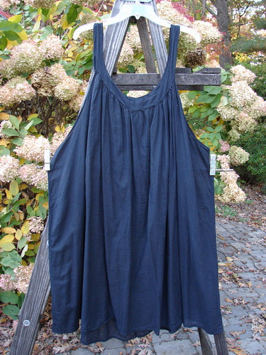 Barclay Batiste Banded Collar Slip Dress in Black, size 2, on a wooden rack.
