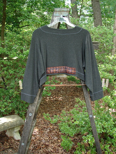 2000 Patched Rayon Lycra Rib Overtop Charcoal Heather Size 1 displayed on a wooden ladder, highlighting its unique Celtic-themed painted patches and dramatic hemline.