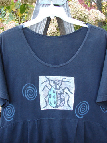 A vintage 1992 Little Storma dress featuring a garden bug theme. Smaller one size fits all. Mid-weight cotton. Deep rounded neckline. Hand-dyed silk ribbon. Blue Fish vintage patch. Bust 44, Waist 44, Hips 44, Length 35.