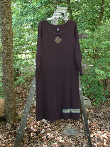 Purple 2000 Patched Rayon Lycra Rib Julia Dress Cassis Heather Size 0 draped on a wooden ladder, showcasing its long, flowing design with crisscross front and gathered forearms.