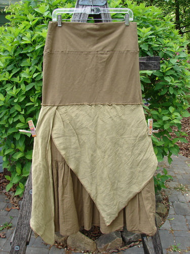 Barclay Fold Over Silk Accent Silhouette Skirt Unpainted Bone Size 0 displayed outdoors, showcasing its layered design with a smooth upper panel and crinkled-texture lower layer, highlighted by a pointed hem.