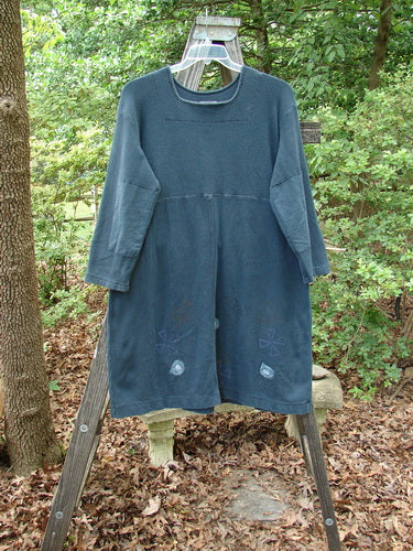 1999 Thermal Home Dress Paisley Peacock Size 0 displayed on a wooden rack, showcasing its unique squared neckline, rectangular elbow patches, and sectional panels with draw cords.