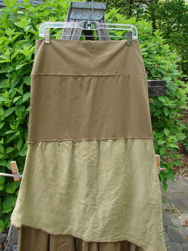 Barclay Fold Over Silk Accent Silhouette Skirt Unpainted Bone Size 0, featuring a tiered design with a soft waistline, displayed on a hanger against a wooden structure, embodying Bluefishfinder.com's vintage style.
