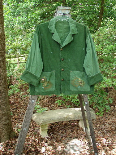 1997 Mason's Jacket Structural Verdigris OSFA draped on a ladder, showcasing its folded neckline, two front painted pockets, cuffed cord sleeves, and detailed metal buttons.