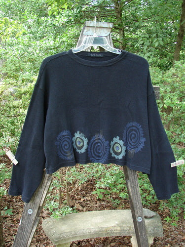 1996 Thermal Boxy Top Gear Black OSFA displayed on a hanger, showcasing its wider boxy shape, drop shoulders, longer sleeves, ribbed neckline, and colorful abstract gear design.