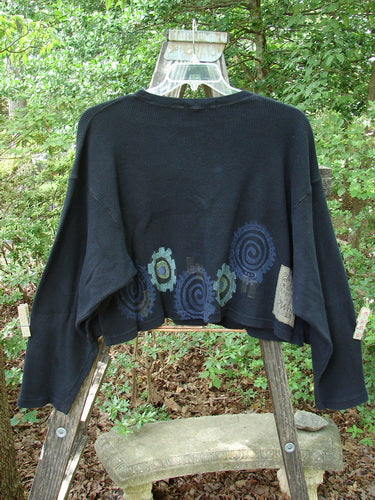 1996 Thermal Boxy Top Gear Black OSFA displayed on a mannequin, highlighting its boxy shape, drop shoulders, longer sleeves, ribbed neckline, and abstract gear art design.