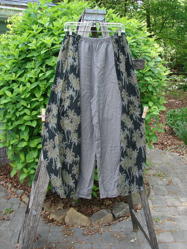 Barclay Linen Pucker Accent 4 Square Pant in Tropical Black Grey Size 0, displayed on a hanger over a wooden ladder. Features an elastic waist, contrasting tropical print panels, and exterior pockets.
