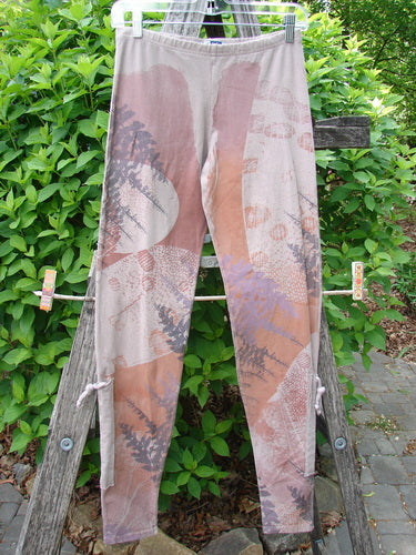 Barclay Cotton Lycra Side Gather Legging Forest Moon Oriel Size 0 displayed outdoors, featuring an elastic waistband, ankle draw-cords, and an abstract print.