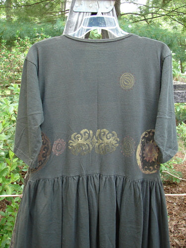 1992 Short Sleeved Simple Dress Metallic Black Sand Altered Size 1, featuring a semi-dropped waist, full draping lower, wider rounded neckline, and signature Blue Fish patch, displayed with a unique metallic design.