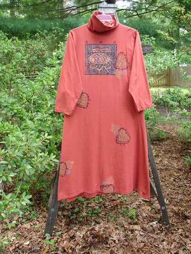 1995 Omega Dress Heart Fish Red Glaze Altered Size 1 on a wooden stand, featuring a heavy ribbed turtleneck, drop shoulders, generous A-line flare, and drawcord backline.