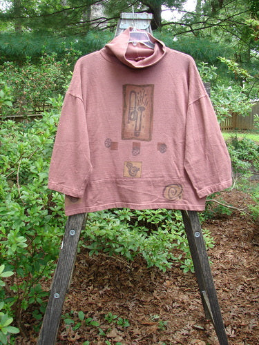 1995 Reprocessed Workshop Top Clay Music Altered Size 2 displayed on a rack, showcasing its loose ribbed turtleneck, drop shoulders, and vented sides.