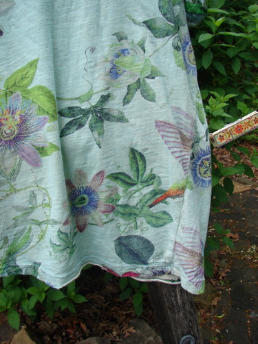 Magnolia Pearl Cotton Jersey Boyfriend Tee Passion Flower Big Sky OSFA, featuring large passion-flower motifs, hangs outdoors. The tee showcases a soft drapey feel with finished, rolled edges and shoulder distressing.