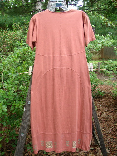 1998 Croquette Dress Games Rover Altered Size 1 displayed on a clothes rack, featuring a shallow rolled neckline, sectional vertical rounded panels, and an empire waist seam in organic cotton.