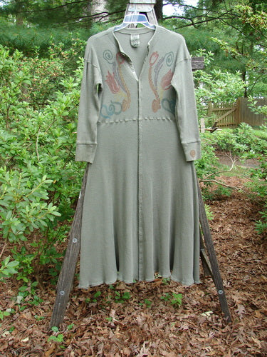 1995 Thermal Soliloquy Dress Abstract Greenwear Altered Size 2 displayed on a wooden stand, showcasing its full length, ribbed accents, and unique architectural design with front snaps and a sweeping hemline.