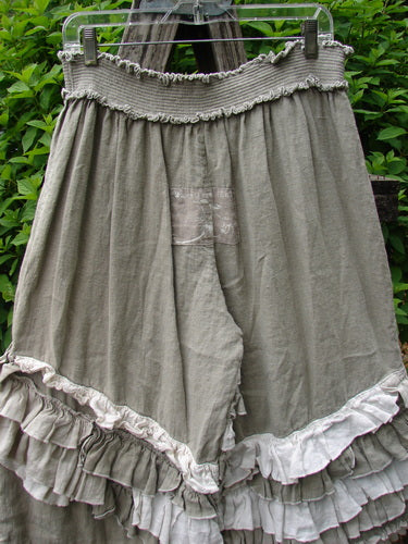 Magnolia Pearl Linen Eiffel Tower Bloomer Flaxen OSFA features knee-length, heathered olive-gray bloomers with layered ruffles and a wide elastic waistband, embodying a vintage, cottage-core aesthetic.