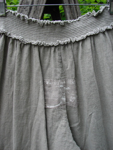 Magnolia Pearl Linen Eiffel Tower Bloomer Flaxen OSFA, showcasing a ruched waistband with ruffle trim and soft gathers. The skirt features a faint rectangular detail, embodying Bluefishfinder.com’s vintage aesthetic.