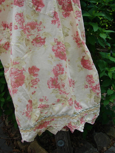 Magnolia Pearl Patched Khloe Bloomer Roses Are Red OSFA hangs outdoors, showcasing vintage-style floral print with red/pink roses on pale fabric, featuring lace trim and distinctive patchwork, embodying Bluefishfinder.com's creative vintage essence.