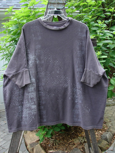 Barclay Fleece Banded Sleeve Dolman Top Diamond Star Dark Stone OSFA displayed on a wooden rack, showcasing its wide boxy shape and banded lower sleeves.