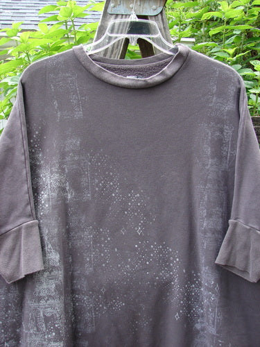 Barclay Fleece Banded Sleeve Dolman Top Diamond Star Dark Stone OSFA on a clothes rack, showcasing its wide boxy shape, banded hemline, and detailed diamond star theme in cozy mid-weight organic cotton fleece.