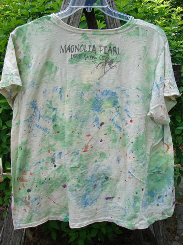 Magnolia Pearl Cotton Jersey Boyfriend Tee Songbird Floral OSFA: Off-white, short-sleeve, tie-dye look with splashes of green, blue, and red. Features include a unique triangle seam and shoulder distressing.
