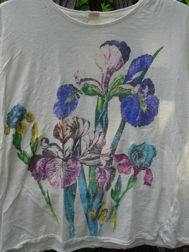 Magnolia Pearl Cotton Jersey Boyfriend Tee Iris Garden OSFA features a vibrant iris-flower print in blues, purples, pinks, and yellows on a lightweight, soft cotton jersey with distressed edges and unique diagonal seam.