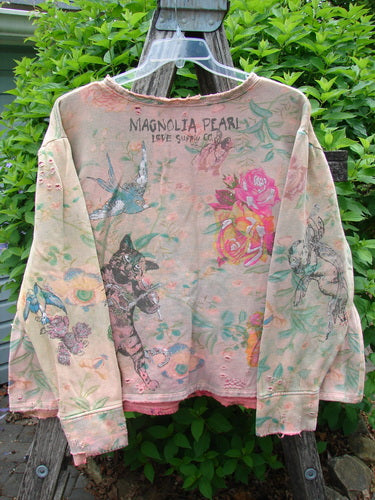 Magnolia Pearl Fleece Lucky Anna Glitter Sweatshirt Marais OSFA features distressed pink fabric adorned with vintage-style prints: roses, birds, a climbing cat, and botanical details, creating a whimsical, artistic look.