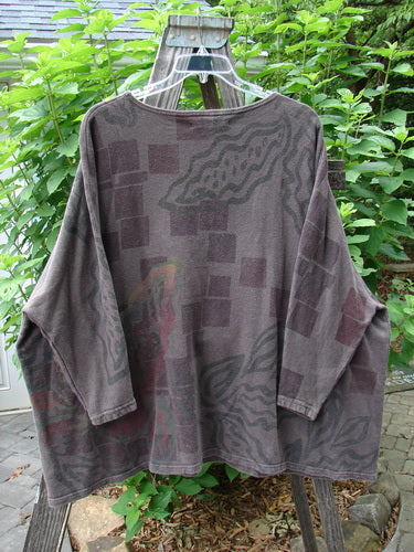 Barclay Cotton Hemp Dolman Sleeve Pullover Top Abstract Continuum Stone OSFA on a clothes rack, showcasing its wide, boxy shape, rounded neckline, dolman sleeves, and abstract pattern.