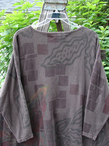 Barclay Cotton Hemp Dolman Sleeve Pullover Top Abstract Continuum Stone OSFA displayed on a wooden clothes rack, highlighting its wide boxy shape, dolman sleeves, and abstract pattern.