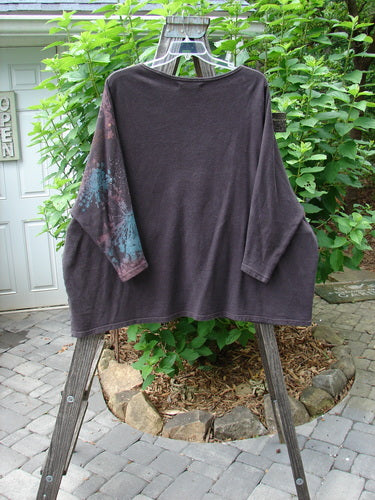 Barclay Cotton Hemp Dolman Sleeve Pullover Top Crane Shadow Mahogany OSFA displayed on a wooden rack, showcasing its wide boxy shape and dolman sleeves with a lower narrowing.