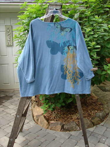 Barclay Cotton Hemp Dolman Sleeve Pullover Top Butterfly Blue Dusk OSFA displayed on a wooden stand, showcasing wide boxy shape, dolman sleeves, and butterfly design.