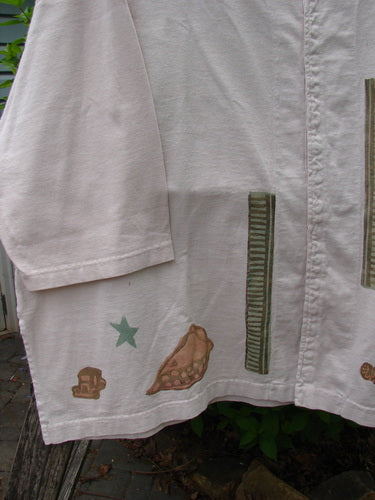 The 1993 Resort PJ Top Diner Treat Tea Dye Size 2 features a light-beige fabric with unique motifs, including a skull, star, shell, and stripes, hanging outdoors, embodying Bluefishfinder.com's vintage charm.