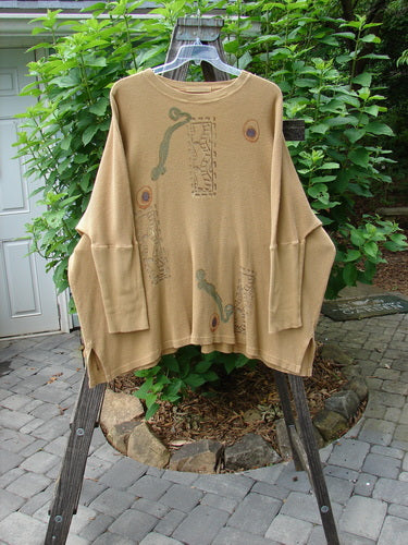 1995 Thermal Studio Pullover Tunic Abstract Road Burnished Gold OSFA displayed on a rack, showcasing its varying and vented sides, ribbed lower sleeves, and whimsical abstract road theme paint.