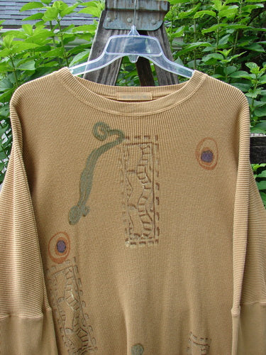 1995 Thermal Studio Pullover Tunic Abstract Road Burnished Gold OSFA displayed on a wooden swing, highlighting its vented sides, ribbed lower sleeves, and relaxed drape.