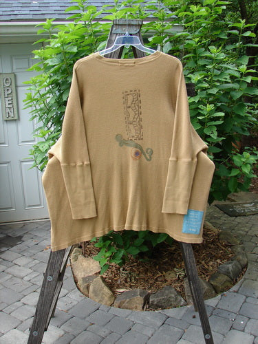 1995 Thermal Studio Pullover Tunic Abstract Road Burnished Gold OSFA displayed on a rack, showcasing its long sleeves, ribbed lower sleeves, and vented sides, with a whimsical abstract road design.