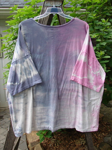 Barclay Oversized Center Seam Tunic Top Unpainted Mottled Pastels OSFA hanging on a clothes rack, showcasing its loose, boxy shape and distinctive center seam.