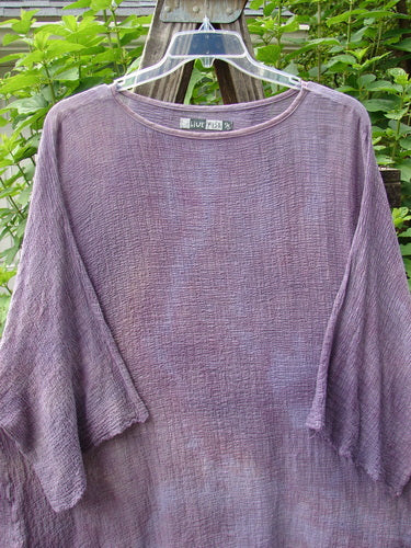 Barclay Gauze Ana Tunic Dress in Mottled Lavender Rain OSFA displayed on a swinging hanger, featuring a rounded neckline and wide three-quarter sleeves with frays.