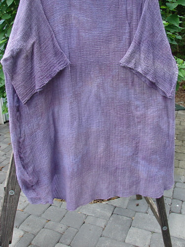 Barclay Gauze Ana Tunic Dress in Mottled Lavender displayed on a rack, featuring three-quarter sleeves, rounded neckline, and varying hemline, showcasing the vintage style from Bluefishfinder.com.