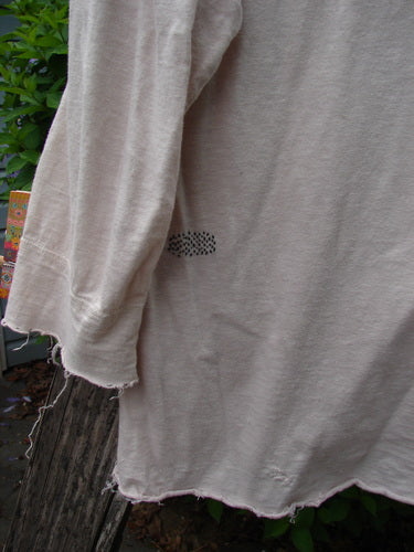 Magnolia Cotton Jersey Tobacco Picker's Henley Tee Tea Stain OSFA, draped outdoors, features raw edges, three-quarter sleeves, henley neckline, pearly buttons, rear stitching accent on lightweight cotton jersey.