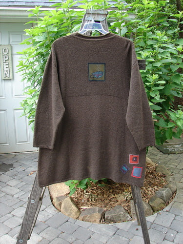 Barclay Patched Favorite Rollneck Alpaca Cotton Tunic Sweater Treeba OSFA displayed on a rack, showcasing its substantial knit, ribbed mock turtleneck, and unique vintage-inspired painted patches.