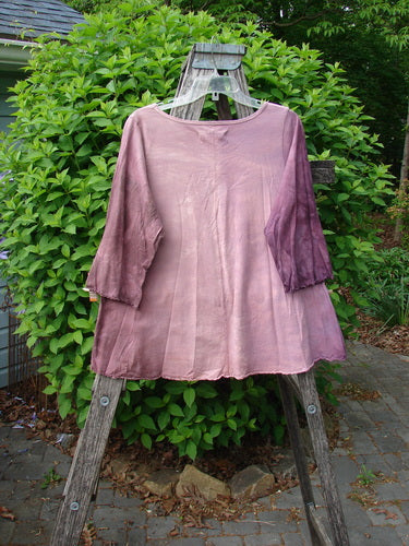Barclay Three Quarter Sleeved Cafe Tee Alphabet Mottled Peony Size 0, draped on a wooden step-ladder outdoors, showcases a gradient tie-dye effect with a relaxed fit and curly edges.