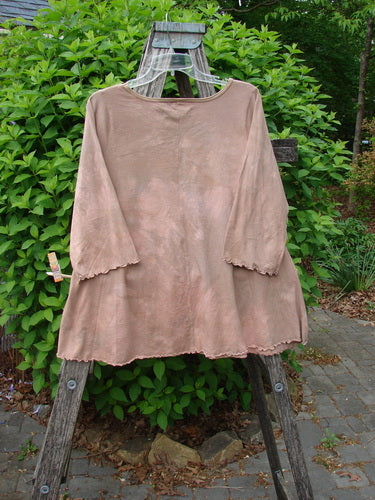 Barclay Three Quarter Sleeved Cafe Tee Freedom Forest Garden Beige Size 0, displayed on a wooden stand, features a loose fit with curly edgings and a flattened neckline, embodying Bluefishfinder's vintage style.