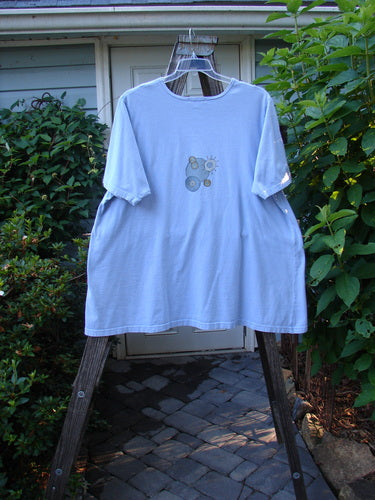 Barclay Short Sleeved A Line Tee Circle Pebble Sky Size 2 on a clothes rack, showcasing a wide boat neckline, swinging A-line shape, and centered circle pebble theme design.