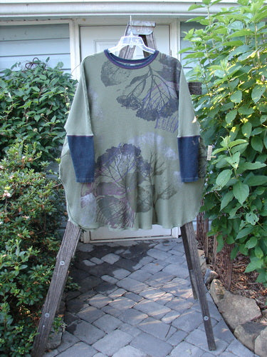 Barclay Thermal Contrast Revival Top Dried Floral Army OSFA displayed on a rack, featuring ribbed sleeves and neckline with a floral paint design.