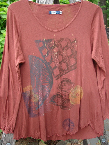 Barclay Modal Long Sleeved A Lined Tee Fall Woods Cassia Size 0 features abstract screen-printed motifs and lettuce-edge ruffles, hanging against greenery, embodying Bluefishfinder.com's vintage-inspired creativity.